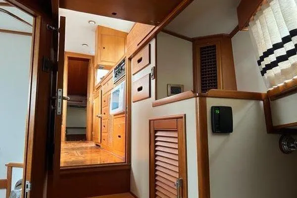 Shearwater Yacht Photos Pics Interior of 2000 Grand Banks 36 Classic yacht, featuring wooden cabinetry and modern appliances.