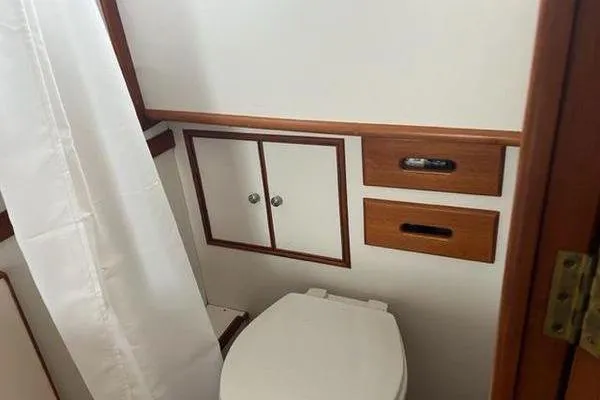 Shearwater Yacht Photos Pics Bathroom interior of 2000 Grand Banks 36 Classic yacht with wooden accents.