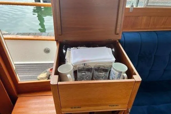 Shearwater Yacht Photos Pics Storage compartment on 2000 Grand Banks 36 Classic yacht with mugs and glasses.