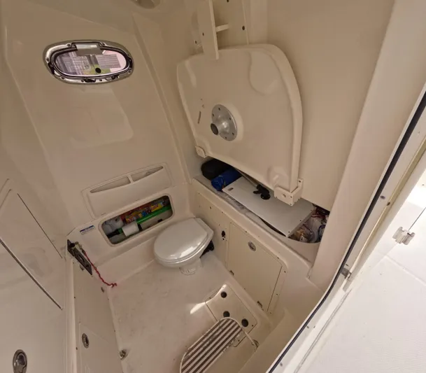  Yacht Photos Pics Interior of 2013 Boston Whaler 320 Outrage boat, featuring a compact marine toilet.