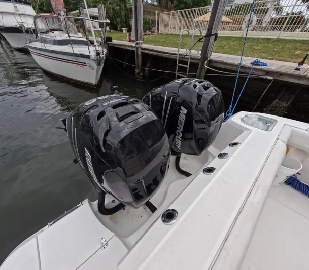  Yacht Photos Pics 2013 Boston Whaler 320 Outrage with dual Mercury outboard engines docked by the water.