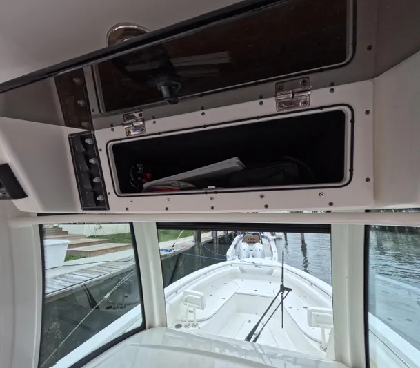  Yacht Photos Pics 2013 Boston Whaler 320 Outrage interior with open storage compartment and view of the deck.