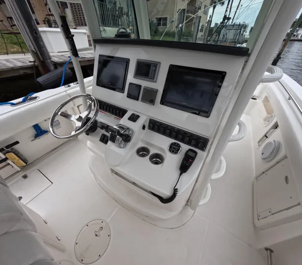  Yacht Photos Pics 2013 Boston Whaler 320 Outrage helm with modern navigation equipment and controls.