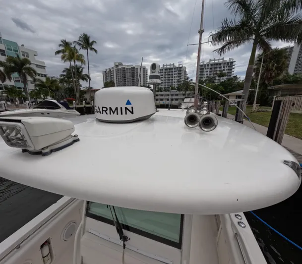  Yacht Photos Pics Boston Whaler 320 Outrage 2013 boat with Garmin radar, docked near palm trees and buildings.