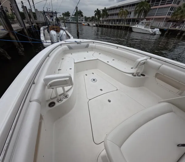  Yacht Photos Pics 2013 Boston Whaler 320 Outrage boat interior, docked near waterfront buildings and palm trees.