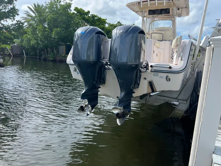  Yacht Photos Pics 2011 Grady-White Canyon 306 boat with dual outboard motors on a calm waterway.
