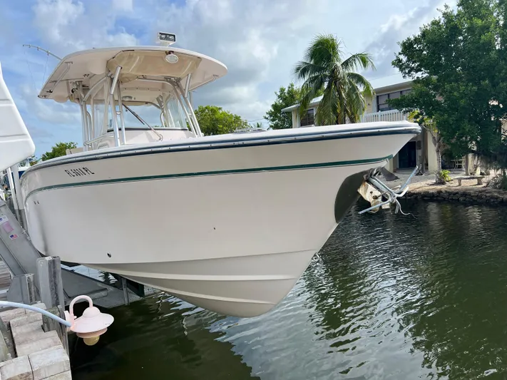  Yacht Photos Pics 2011 Grady-White Canyon 306 boat docked by waterfront with palm trees.