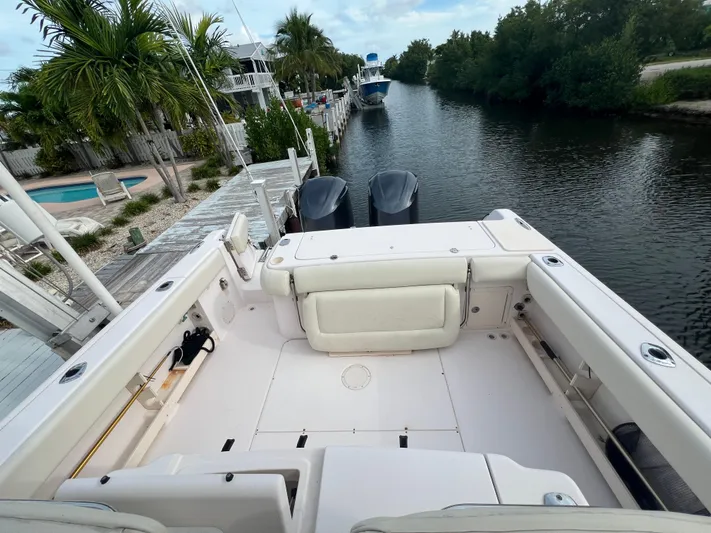 Yacht Photos Pics 2011 Grady-White Canyon 306 boat docked by a scenic canal.