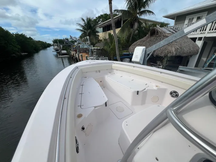  Yacht Photos Pics 2011 Grady-White Canyon 306 boat docked by a scenic canal with palm trees.