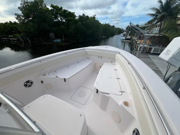  Yacht Photos Pics 2011 Grady-White Canyon 306 boat on a scenic waterway with lush greenery.