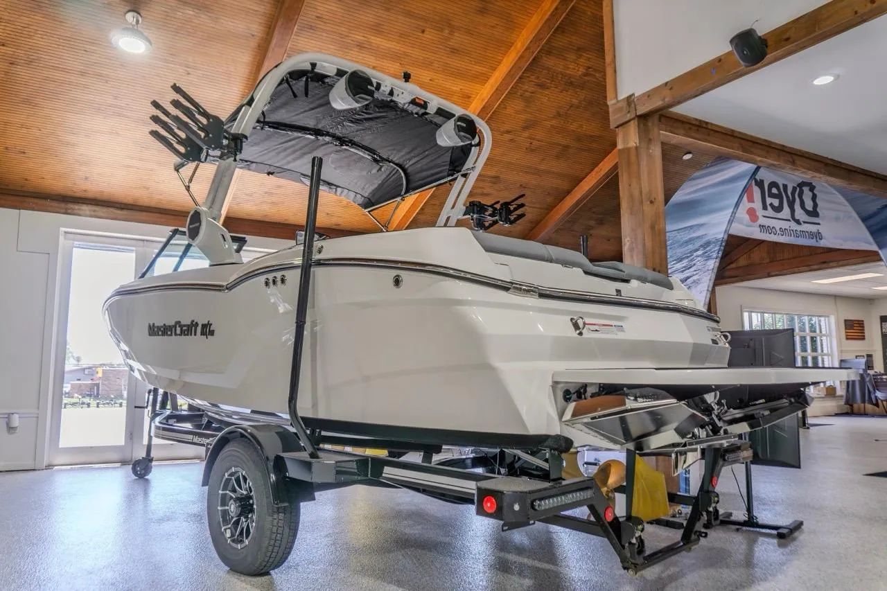 2026 MasterCraft NXT20 boat displayed indoors on a trailer, showcasing sleek design.