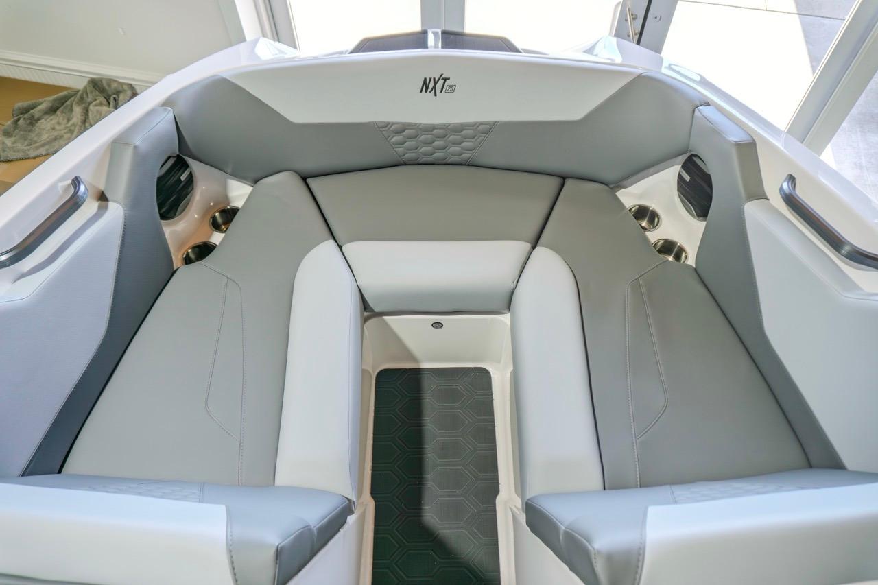 2026 MasterCraft NXT20 boat interior with gray seating and cup holders.