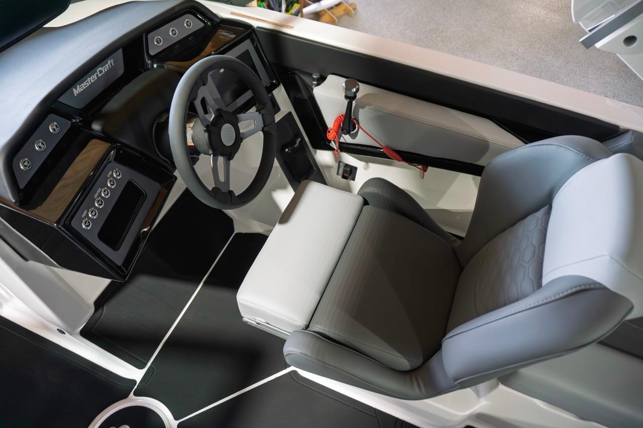 2026 MasterCraft NXT20 boat interior with modern steering and seating design.