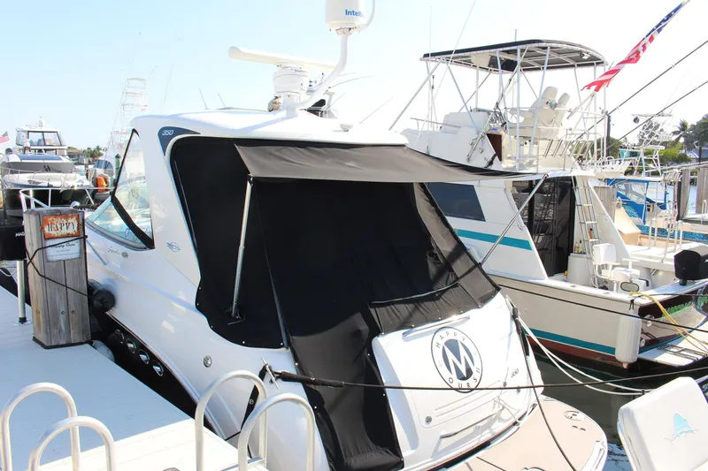 Happy Ours Yacht Photos Pics 2008 Chaparral 350 Signature Extended Plane yacht docked at marina with black canopy.