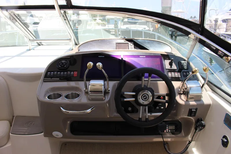 Happy Ours Yacht Photos Pics Cockpit of 2008 Chaparral 350 Signature Extended Plane with steering wheel and controls.