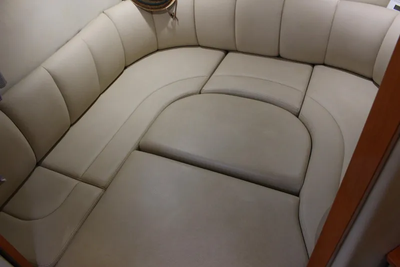 Happy Ours Yacht Photos Pics 2008 Chaparral 350 Signature cabin interior with beige cushioned seating.