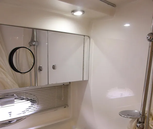 Happy Ours Yacht Photos Pics 2008 Chaparral 350 Signature bathroom with sleek cabinets and modern lighting.