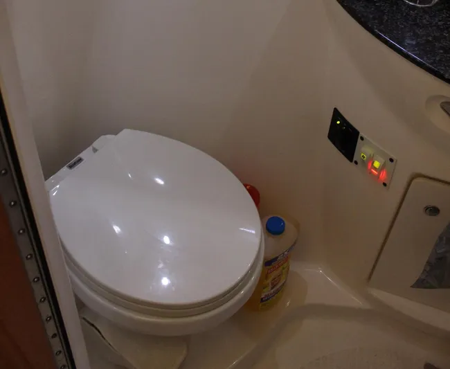 Happy Ours Yacht Photos Pics 2008 Chaparral 350 Signature boat bathroom with toilet and cleaning supplies.