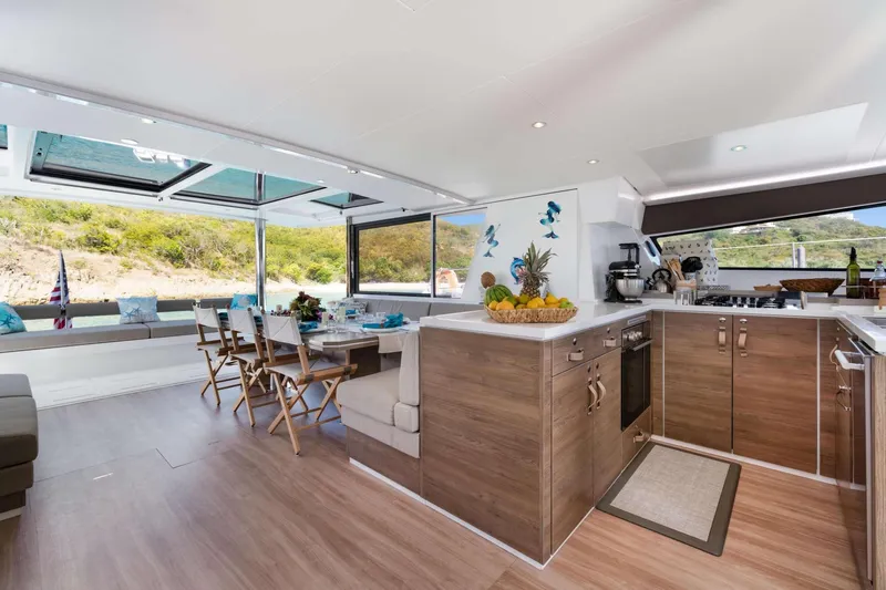 C Sisters Yacht Photos Pics Luxurious interior of 2023 Bali 5.4 Catamaran with modern kitchen and dining area.