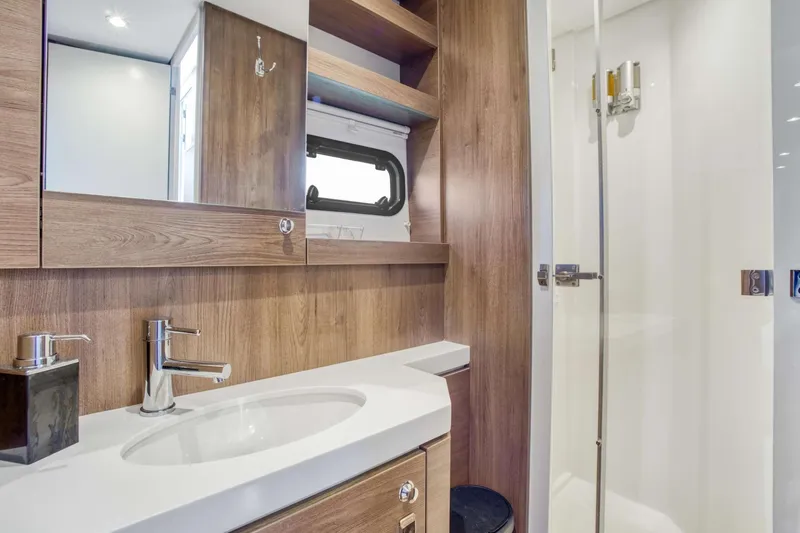 C Sisters Yacht Photos Pics Modern bathroom interior on 2023 Bali 5.4 Catamaran, featuring wood accents and sleek fixtures.