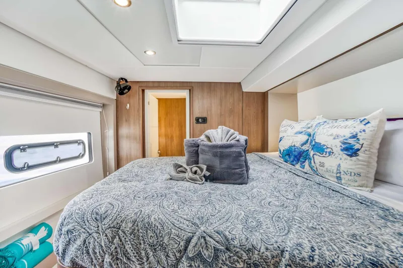 C Sisters Yacht Photos Pics Luxurious bedroom interior of 2023 Bali 5.4 Catamaran with elegant bedding and natural light.