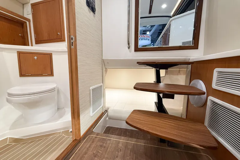 In Stock Yacht Photos Pics Interior of 2026 MJM 47X yacht featuring wooden steps and a compact bathroom.