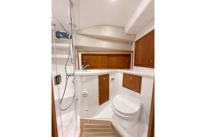 In Stock Yacht Photos Pics Luxurious bathroom in 2026 MJM 47X yacht with wooden cabinets and modern fixtures.