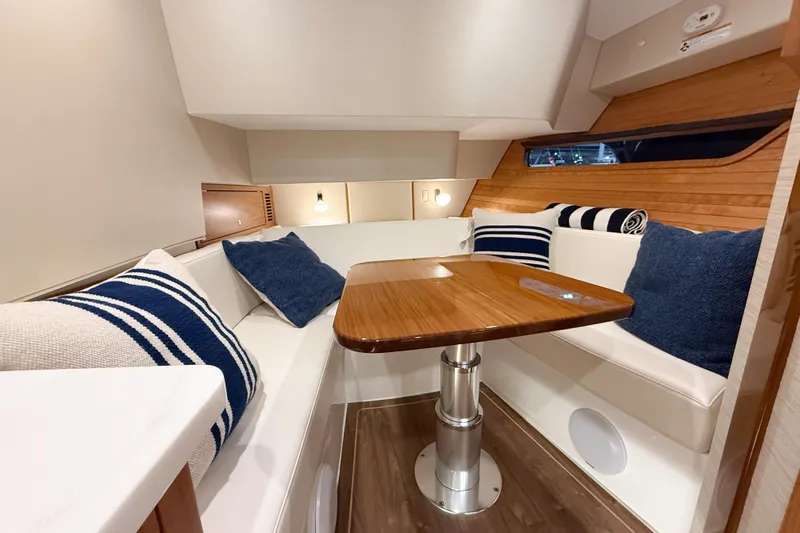 In Stock Yacht Photos Pics Luxurious interior of 2026 MJM 47X yacht with elegant seating and wooden table.