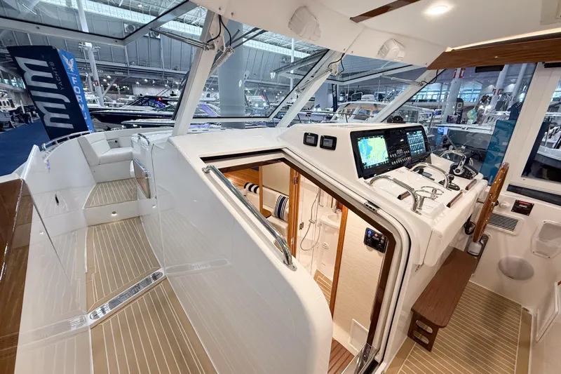In Stock Yacht Photos Pics Interior view of 2026 MJM 47X yacht showcasing helm and seating area.