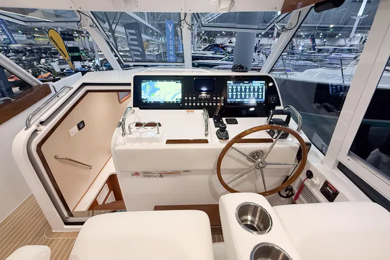 In Stock Yacht Photos Pics Helm of 2026 MJM 47X yacht with advanced navigation displays and wooden steering wheel.