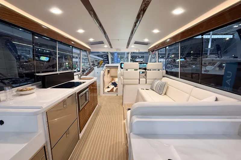 In Stock Yacht Photos Pics Luxurious interior of 2026 MJM 47X yacht with modern kitchen and seating area.