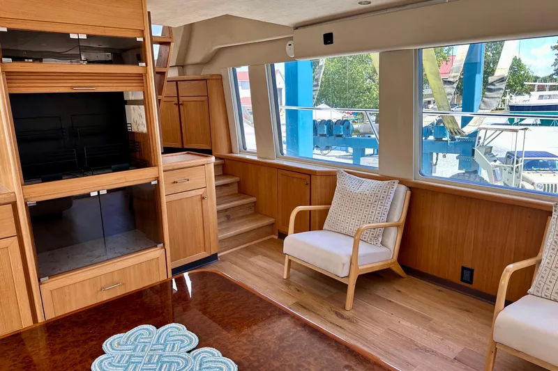 Chasing Sunsets Yacht Photos Pics Interior of 2000 Pacific Mariner 65 Motoryacht with wooden cabinetry and seating.