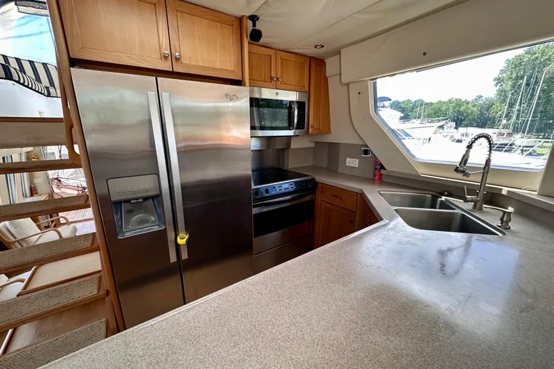 Chasing Sunsets Yacht Photos Pics Kitchen interior of 2000 Pacific Mariner 65 Motoryacht with stainless steel appliances.