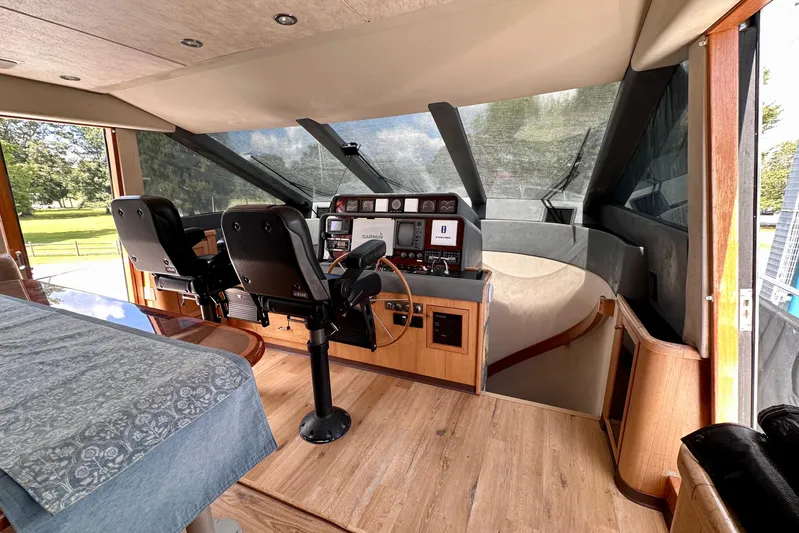Chasing Sunsets Yacht Photos Pics Interior view of 2000 Pacific Mariner 65 Motoryacht helm with dual seats and navigation equipment.