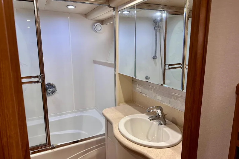 Chasing Sunsets Yacht Photos Pics Bathroom interior of 2000 Pacific Mariner 65 Motoryacht with shower and sink.