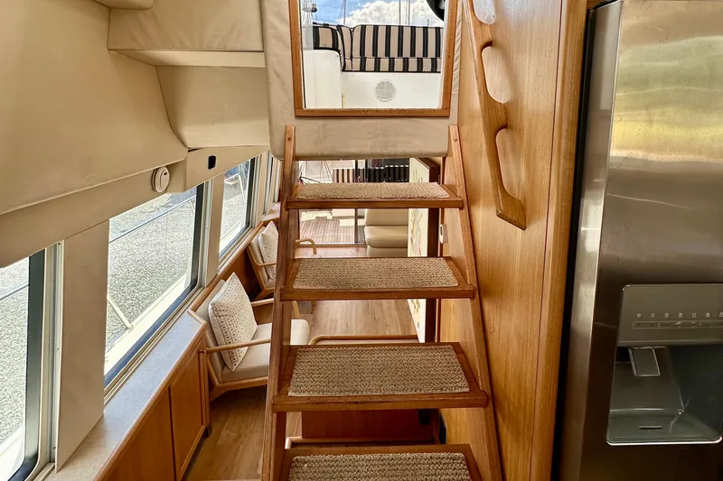 Chasing Sunsets Yacht Photos Pics Interior of 2000 Pacific Mariner 65 Motoryacht with wooden stairs and modern design.