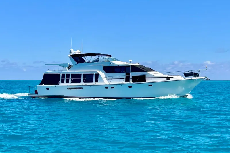 Chasing Sunsets Yacht Photos Pics 2000 Pacific Mariner 65 Motoryacht cruising on clear blue ocean waters.