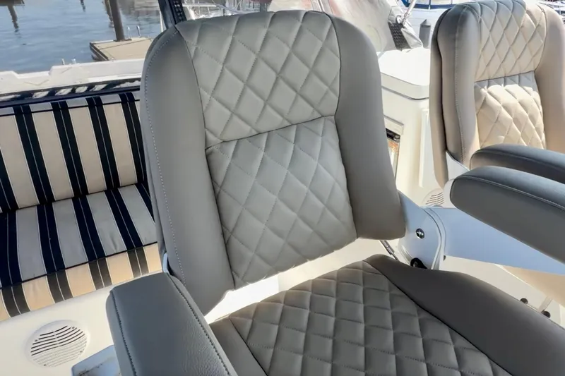 Chasing Sunsets Yacht Photos Pics Luxurious seating on 2000 Pacific Mariner 65 Motoryacht with quilted upholstery and striped cushions.