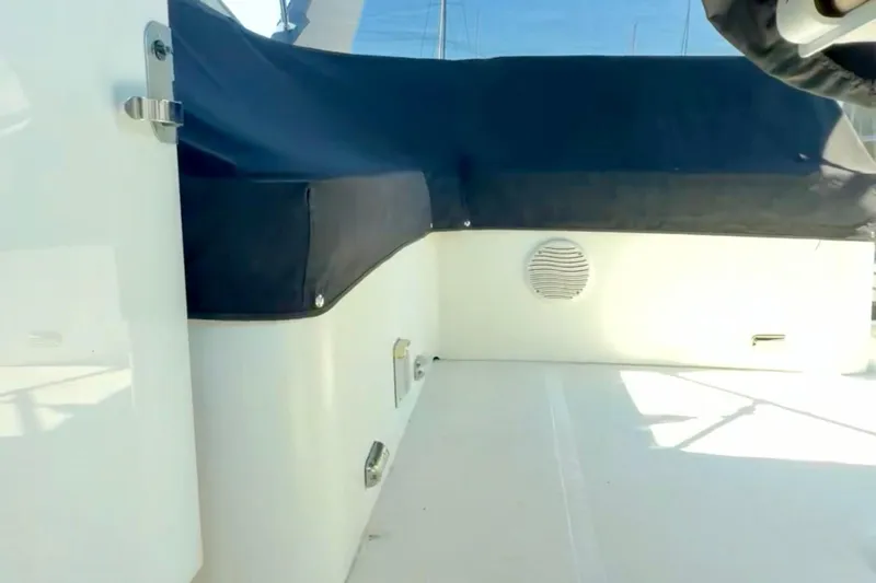 Chasing Sunsets Yacht Photos Pics 2000 Pacific Mariner 65 Motoryacht interior with blue seating and speaker.