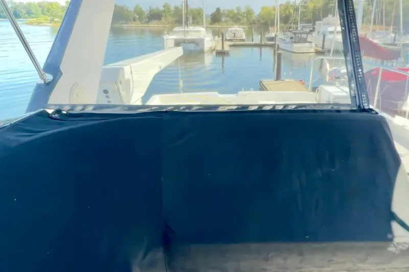 Chasing Sunsets Yacht Photos Pics 2000 Pacific Mariner 65 Motoryacht docked at a marina with scenic water view.