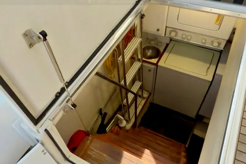 Chasing Sunsets Yacht Photos Pics Laundry area in 2000 Pacific Mariner 65 Motoryacht with washer, dryer, and sink.