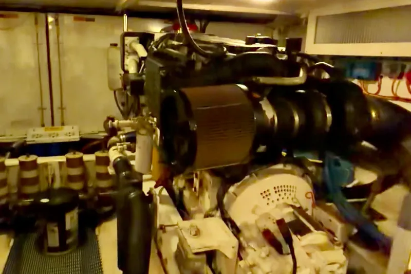 Chasing Sunsets Yacht Photos Pics Engine room of a 2000 Pacific Mariner 65 Motoryacht, showcasing mechanical components.