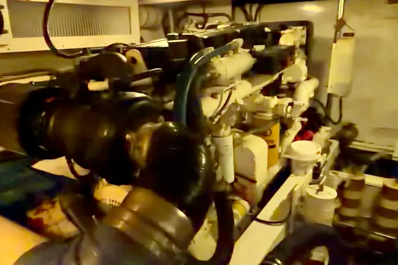 Chasing Sunsets Yacht Photos Pics Engine room of 2000 Pacific Mariner 65 Motoryacht, showcasing complex machinery and components.