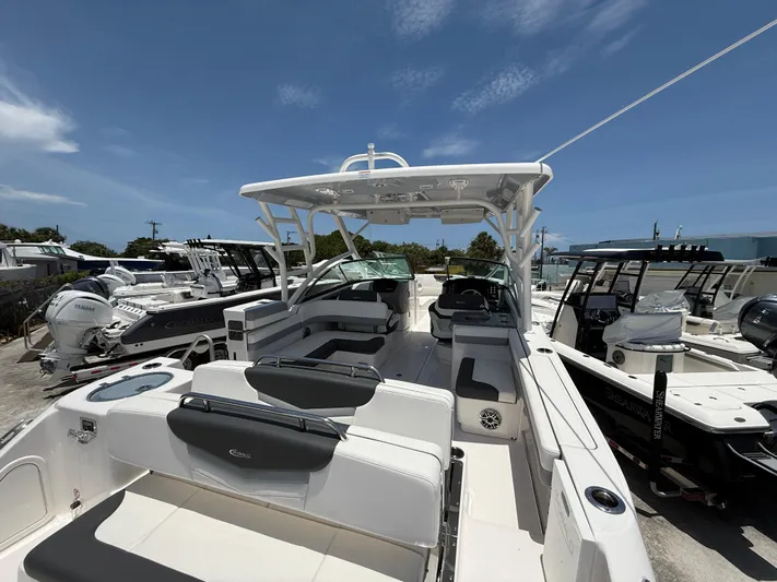 317-125 Yacht Photos Pics 2024 Robalo R317 Dual Console boat with spacious seating and modern design, docked under clear skies.
