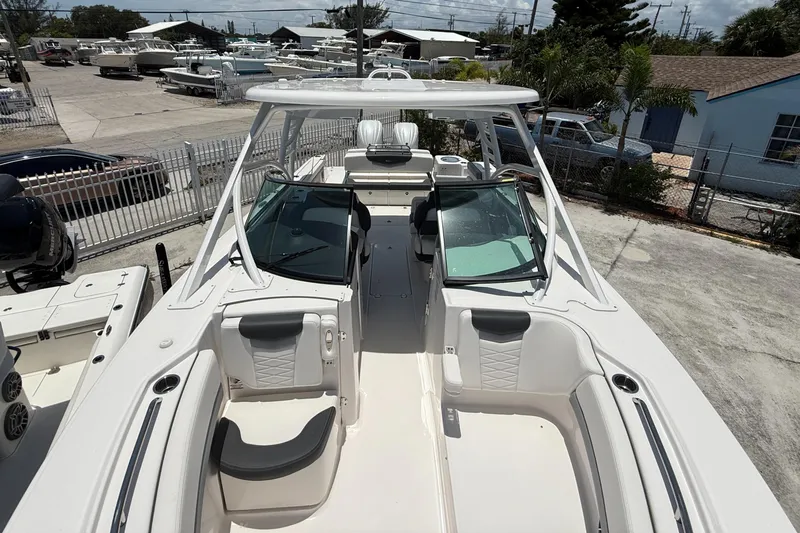 317-125 Yacht Photos Pics 2024 Robalo R317 Dual Console boat with spacious seating and sleek design in a marina setting.