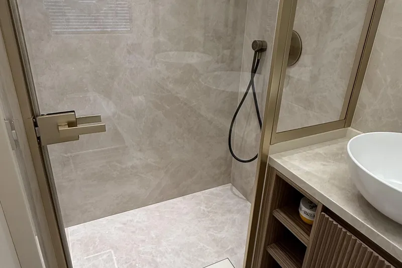 Explocean 3 Yacht Photos Pics Modern bathroom with marble shower, sleek fixtures, and a vessel sink in Explorer 62, 2025 model.