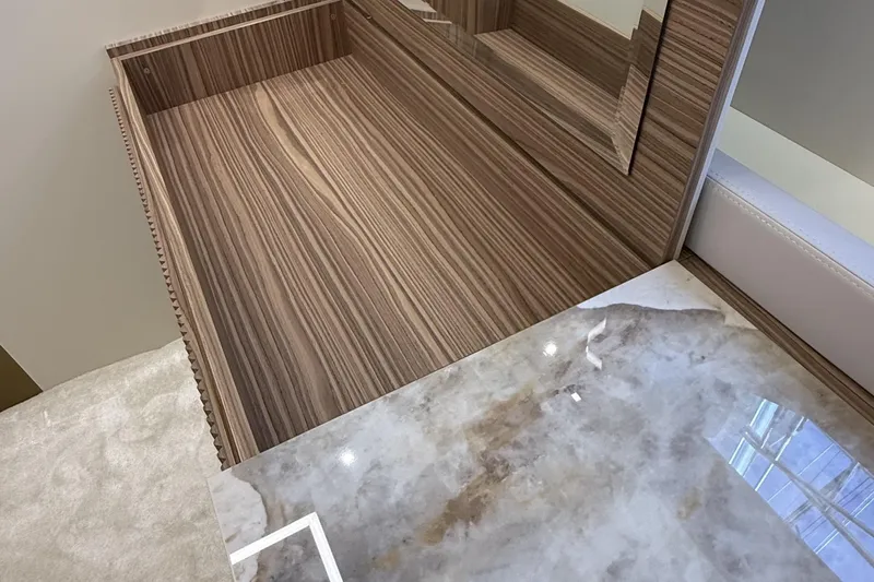 Explocean 3 Yacht Photos Pics Luxurious interior of 2025 Explorer 62 yacht featuring wood and marble finishes.