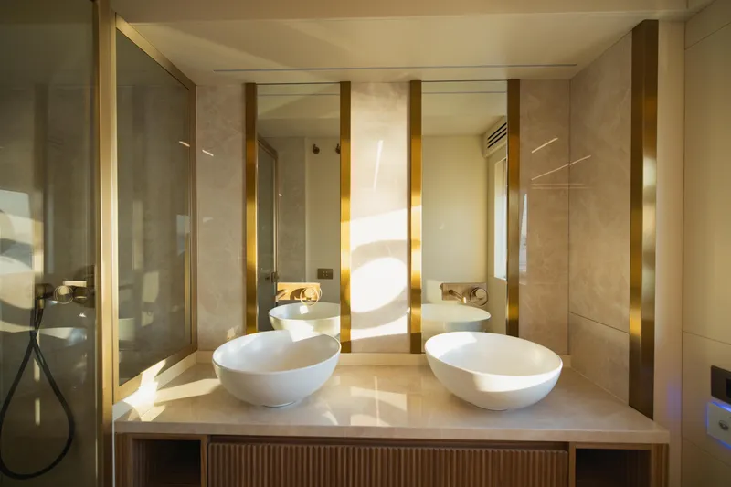 Explocean 3 Yacht Photos Pics Luxurious bathroom with dual sinks and gold accents in 2025 Explorer 62 model.