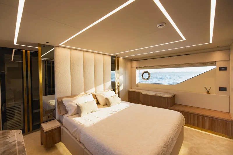 Explocean 3 Yacht Photos Pics Luxurious bedroom interior of 2025 Explorer 62 yacht with ocean view window.