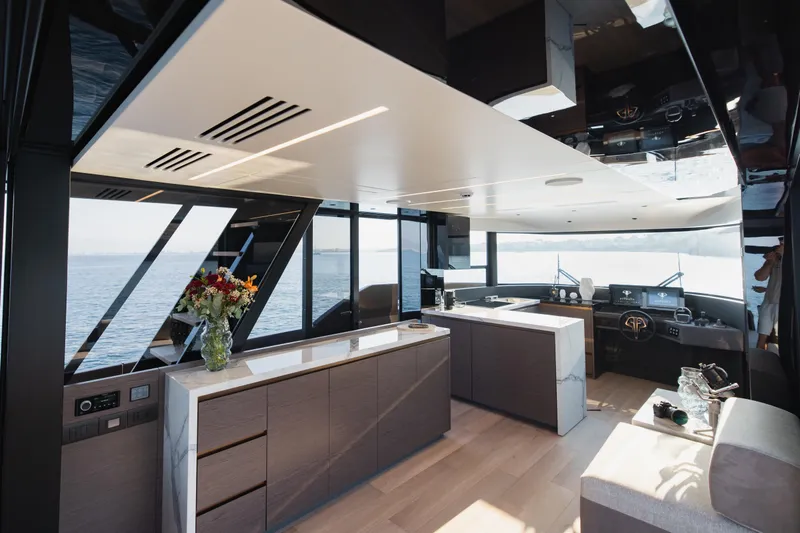 Explocean 3 Yacht Photos Pics Luxurious interior of 2025 Explorer 62 yacht with modern kitchen and panoramic sea view.